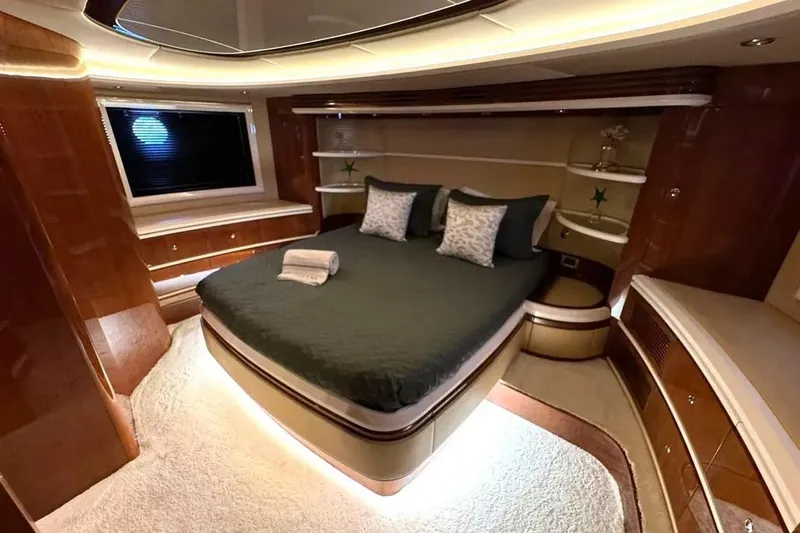 Yacht Photos Pics Luxurious bedroom interior of 2003 Azimut 98 Leonardo yacht with elegant wood finishes.