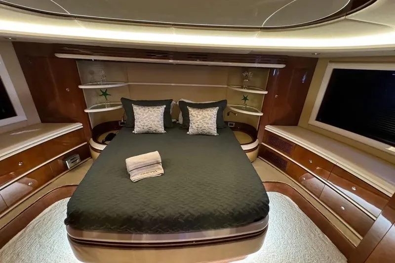  Yacht Photos Pics Luxurious bedroom interior of 2003 Azimut 98 Leonardo yacht with elegant wood finishes.