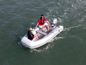 2023 Highfield Classic 260 inflatable boat on water with two passengers.