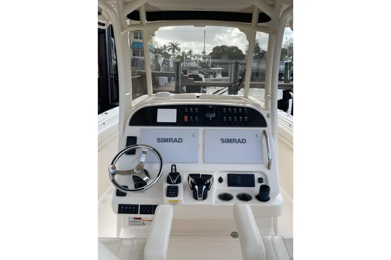  Yacht Photos Pics 2023 Grady-White Canyon 306 boat console with Simrad electronics and steering wheel.