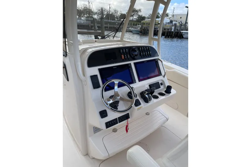  Yacht Photos Pics 2023 Grady-White Canyon 306 boat helm with dual screens and steering wheel.
