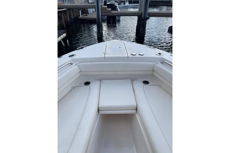  Yacht Photos Pics 2023 Grady-White Canyon 306 boat interior with white seating, docked by the water.