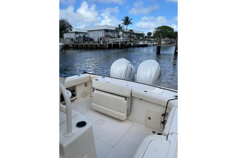  Yacht Photos Pics 2023 Grady-White Canyon 306 boat with Yamaha engines docked by waterfront.