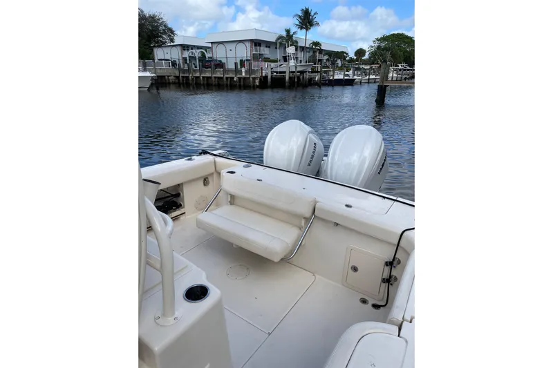  Yacht Photos Pics 2023 Grady-White Canyon 306 boat with twin Yamaha engines docked by the water.