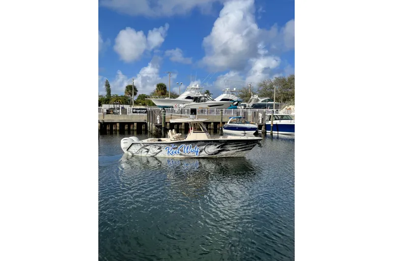  Yacht Photos Pics 2023 Grady-White Canyon 306 boat docked, featuring custom "Reel Wolf" design.