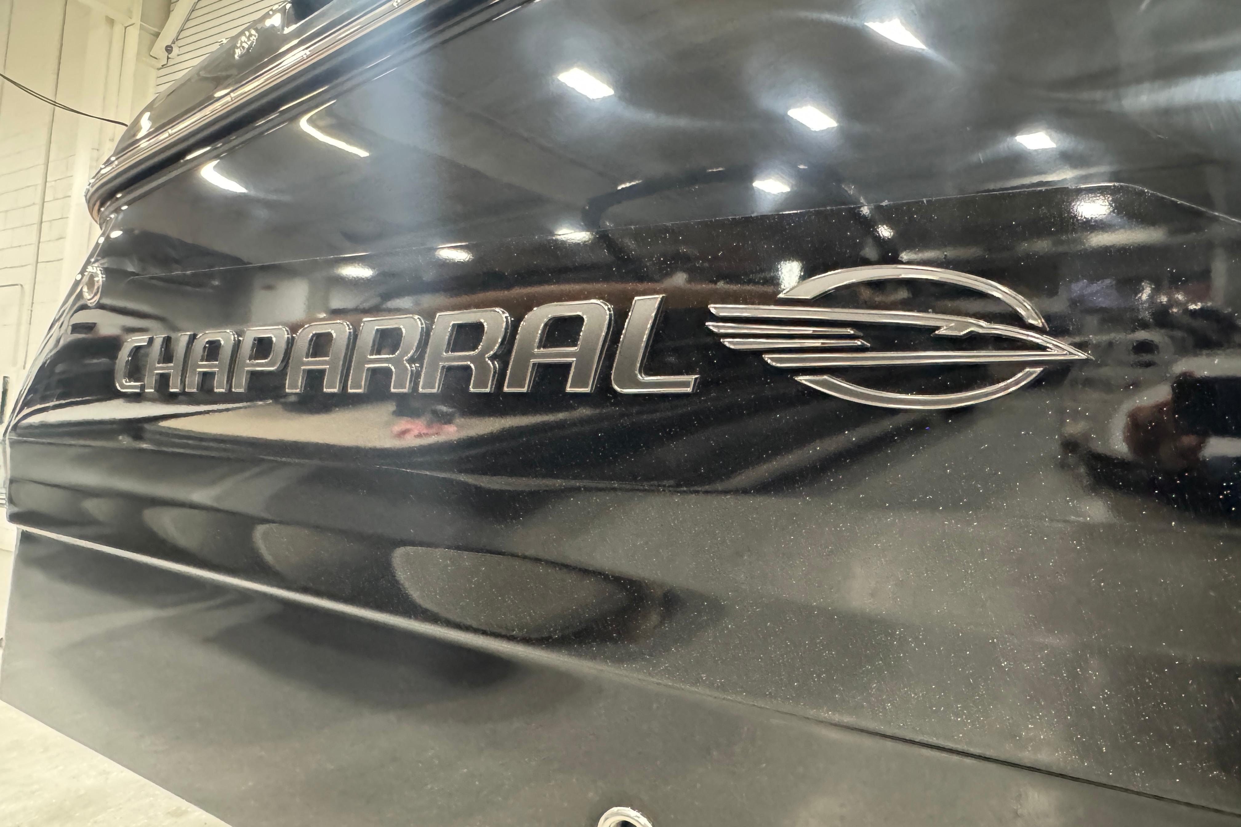 2026 Chaparral 6 SSX boat logo in a showroom setting.