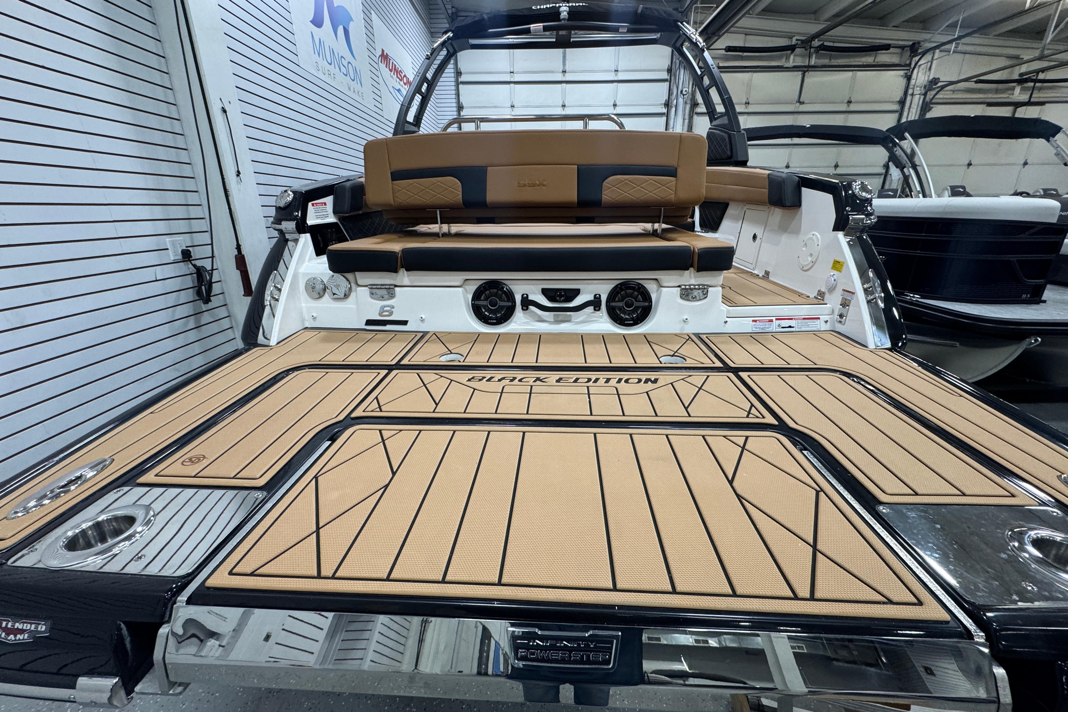 2026 Chaparral 6 SSX Black Edition boat interior with tan and black seating.