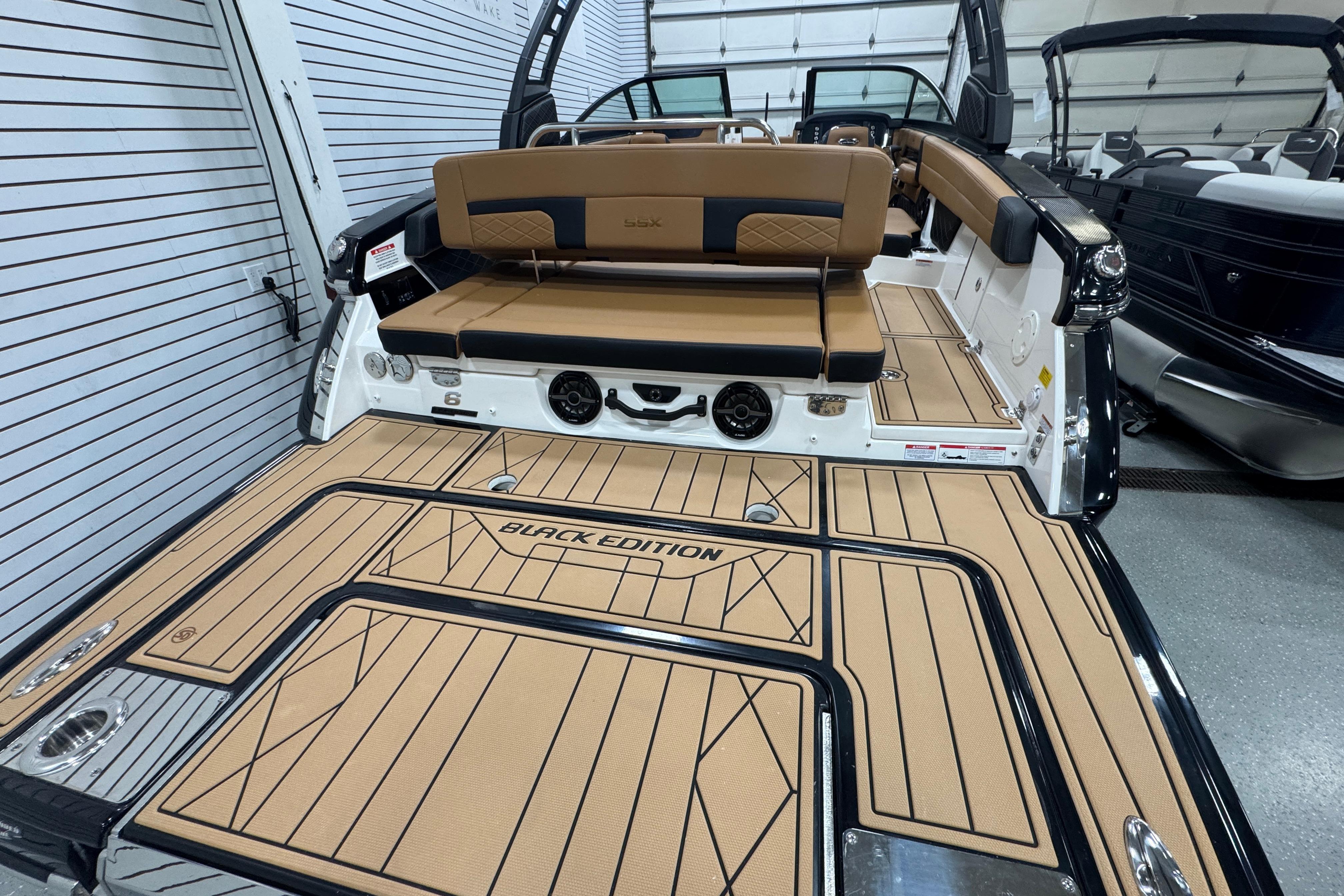 2026 Chaparral 6 SSX Black Edition boat interior with tan and black seating.