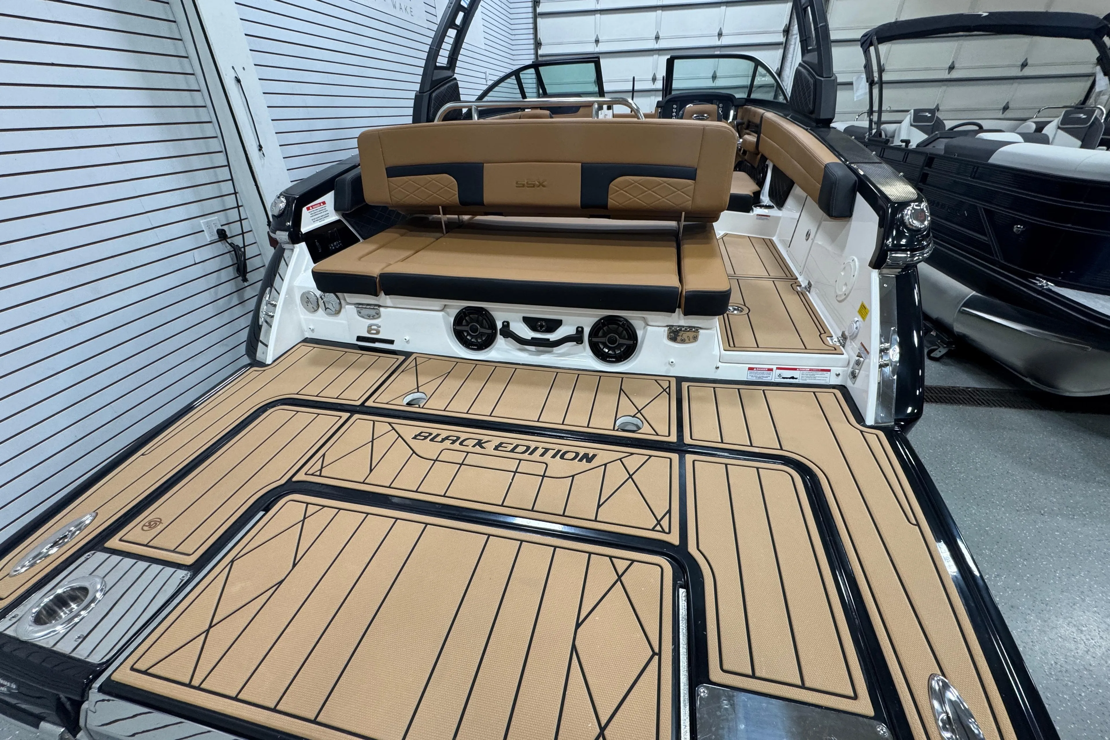 2026 Chaparral 6 SSX Black Edition boat interior with tan and black seating.