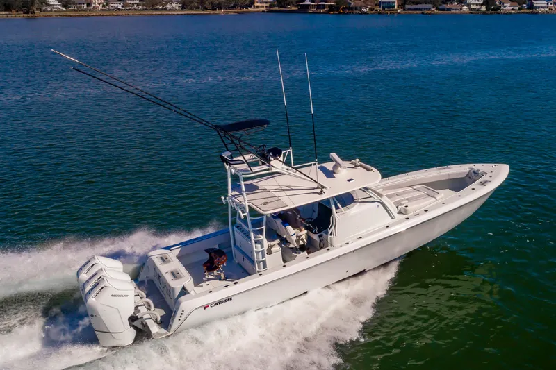 Fin Print Yacht Photos Pics 2023 Contender 44FA 44ST boat cruising on water with triple Mercury engines.
