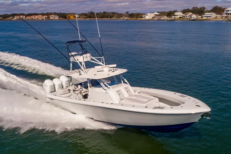 Fin Print Yacht Photos Pics 2023 Contender 44FA 44ST boat cruising on open water, showcasing sleek design and powerful engines.