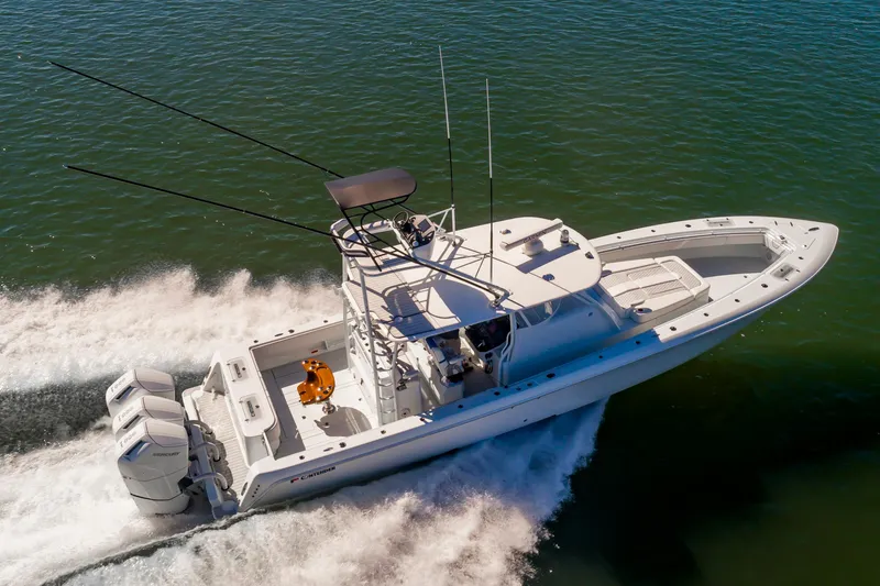 Fin Print Yacht Photos Pics 2023 Contender 44FA 44ST boat cruising on water, aerial view.