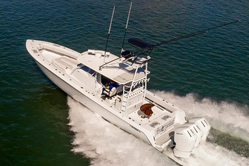 Fin Print Yacht Photos Pics 2023 Contender 44FA 44ST boat cruising on open water, equipped with triple Mercury engines.