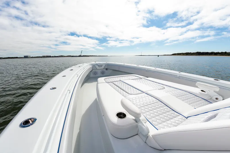 Fin Print Yacht Photos Pics 2023 Contender 44FA 44ST boat on calm water, featuring luxurious white seating.