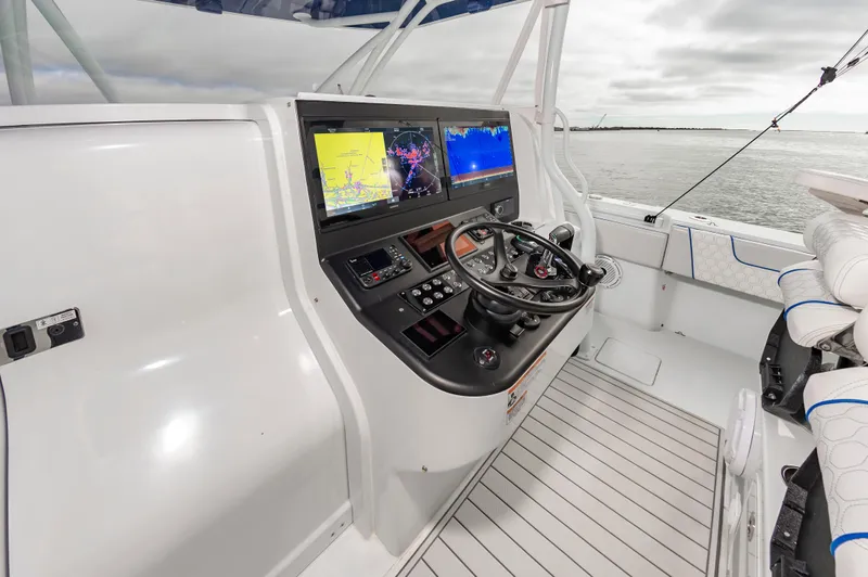 Fin Print Yacht Photos Pics 2023 Contender 44FA boat cockpit with advanced navigation displays and steering controls.