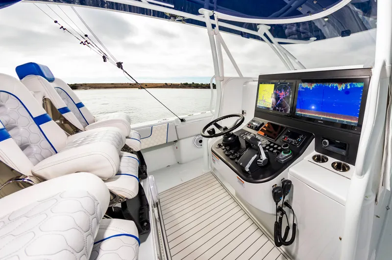 Fin Print Yacht Photos Pics 2023 Contender 44FA boat cockpit with advanced navigation systems and luxurious seating.