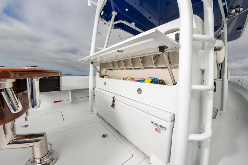 Fin Print Yacht Photos Pics 2023 Contender 44FA boat with open storage compartment and fishing gear.