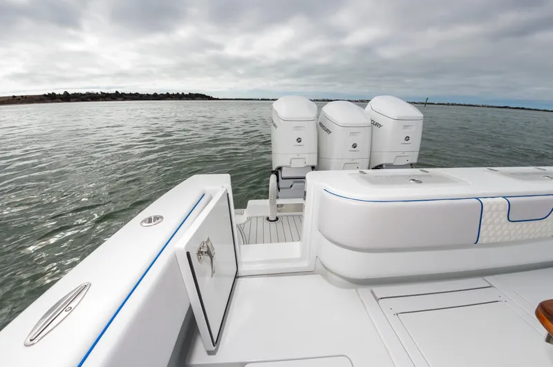 Fin Print Yacht Photos Pics 2023 Contender 44FA boat with triple Mercury engines on calm water.