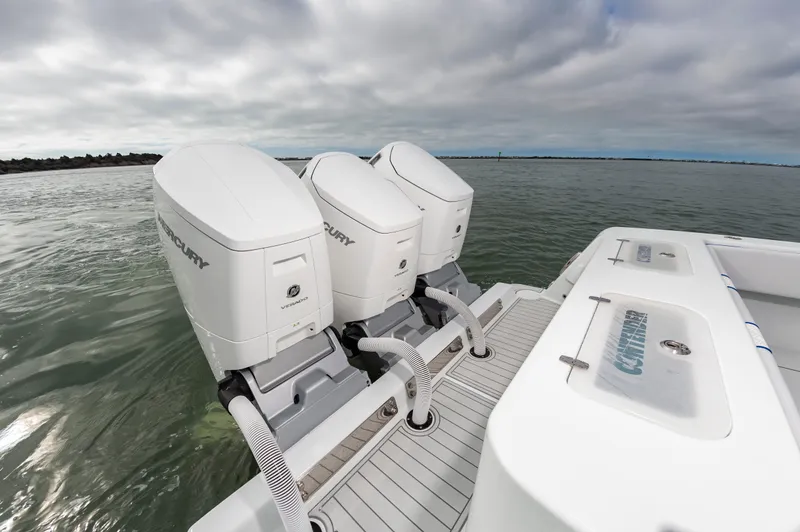 Fin Print Yacht Photos Pics 2023 Contender 44FA boat with triple Mercury outboard engines on open water.