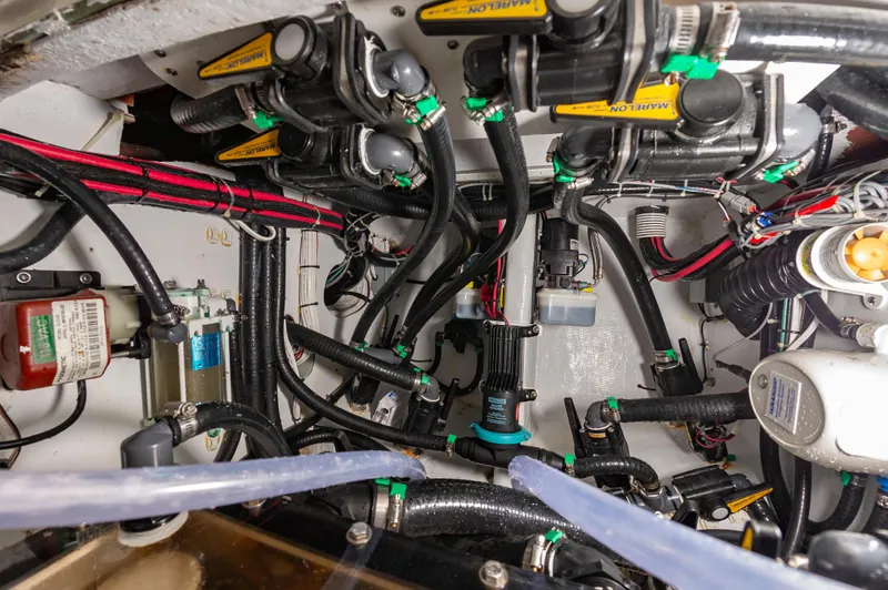 Fin Print Yacht Photos Pics Engine room of 2023 Contender 44FA boat, showcasing complex wiring and mechanical components.
