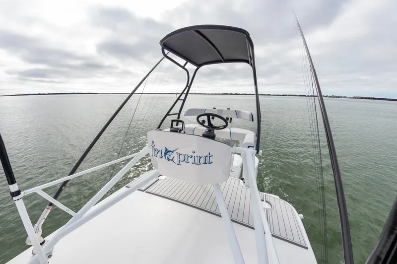 Fin Print Yacht Photos Pics 2023 Contender 44FA boat with elevated helm, steering wheel, and open water view.