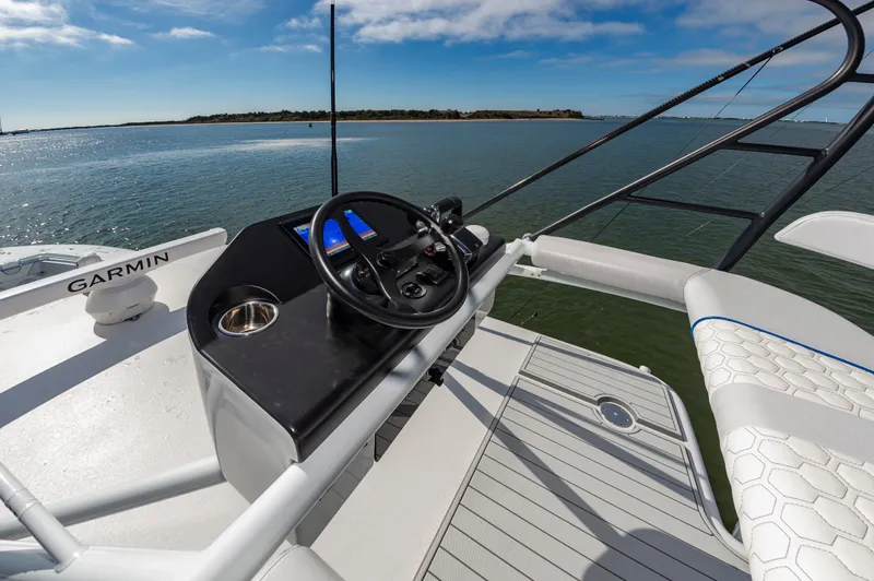 Fin Print Yacht Photos Pics 2023 Contender 44FA boat helm with Garmin navigation, overlooking serene waters.