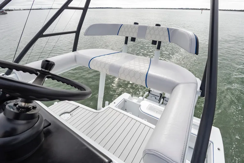 Fin Print Yacht Photos Pics 2023 Contender 44FA boat helm with cushioned seating on calm water.