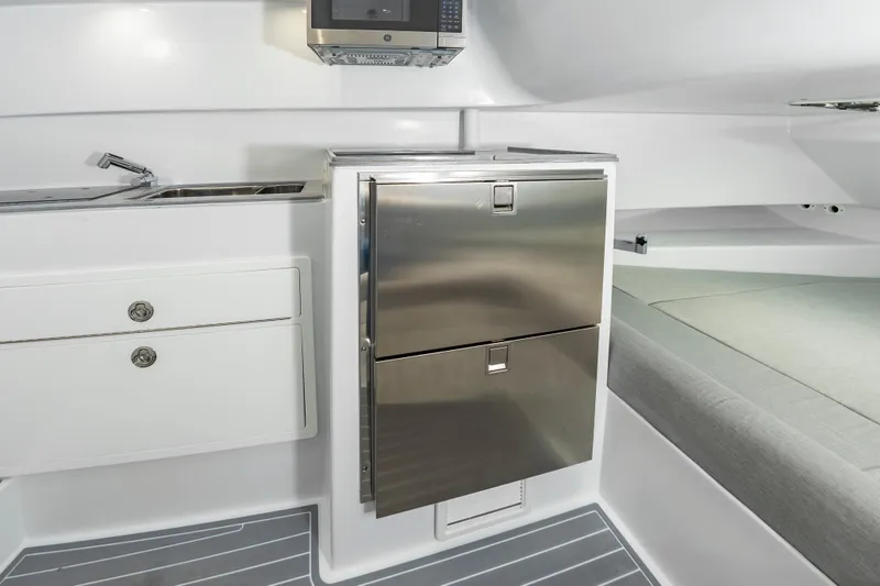 Fin Print Yacht Photos Pics 2023 Contender 44FA boat interior with stainless steel fridge, sink, and modern cabinetry.