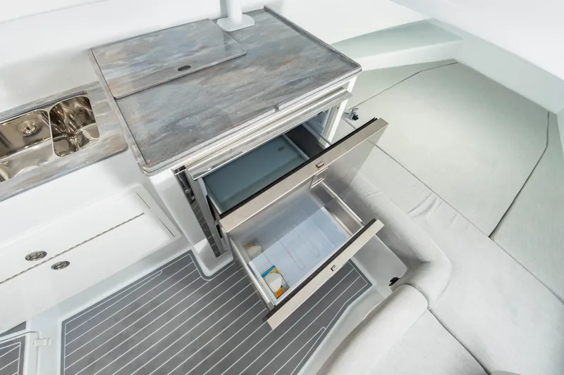 Fin Print Yacht Photos Pics 2023 Contender 44FA yacht interior with open stainless steel refrigerator and sink.