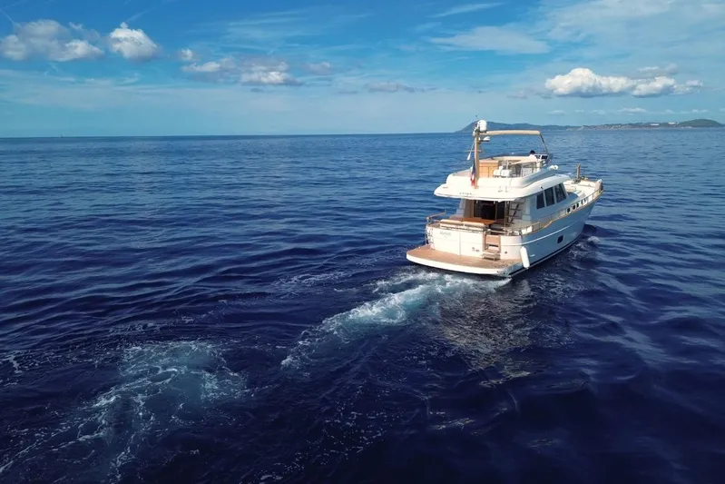  Yacht Photos Pics 2026 Sasga Yachts 55 cruising on open sea under clear blue sky.