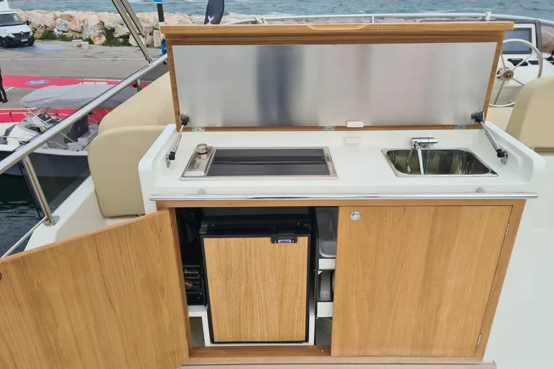  Yacht Photos Pics Outdoor kitchenette on 2026 Sasga Yachts 55, featuring grill, sink, and storage.