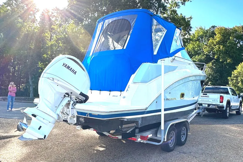  Yacht Photos Pics 2022 Regal 26XO boat with blue canopy and Yamaha outboard motor on trailer.