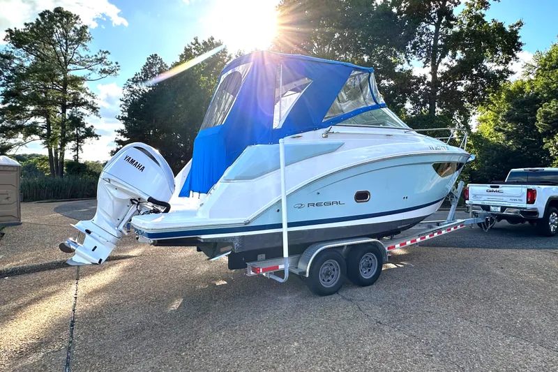  Yacht Photos Pics 2022 Regal 26XO boat on trailer with Yamaha outboard motor, parked outdoors.