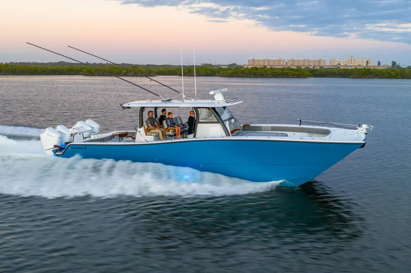  Yacht Photos Pics 2025 Freeman 43 boat cruising on water at sunset with passengers onboard.