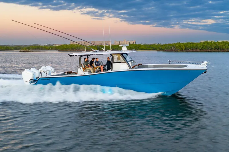  Yacht Photos Pics 2025 Freeman 43 boat cruising on water at sunset with passengers onboard.