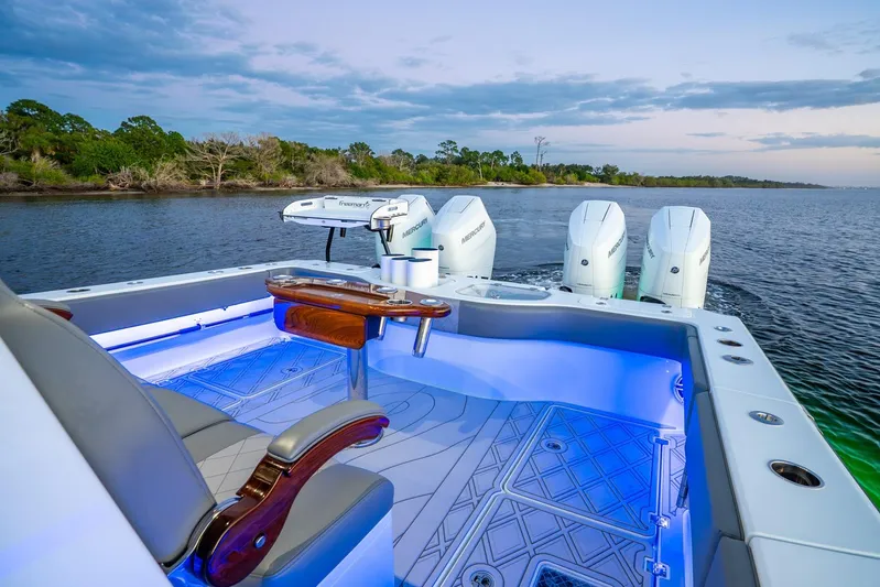  Yacht Photos Pics 2025 Freeman 43 boat with illuminated deck and powerful Mercury engines on a serene waterway.