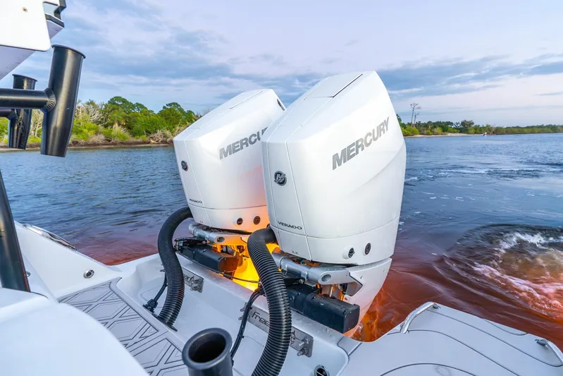  Yacht Photos Pics Twin Mercury outboard engines on a 2025 Freeman 43 boat, cruising on a scenic river.