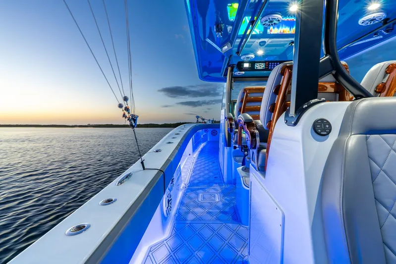  Yacht Photos Pics Luxurious 2025 Freeman 43 boat interior with blue LED lighting at sunset on the water.
