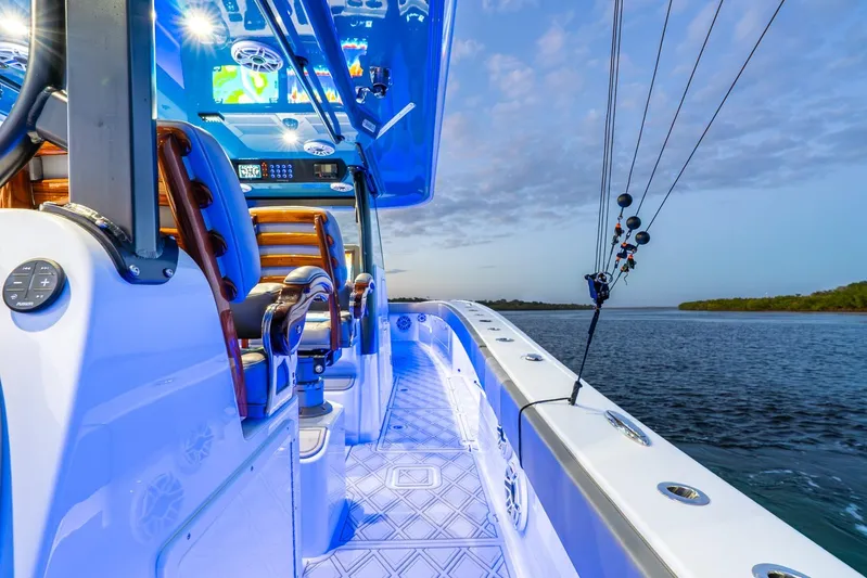  Yacht Photos Pics Luxurious 2025 Freeman 43 boat interior with advanced controls, overlooking serene waters at sunset.