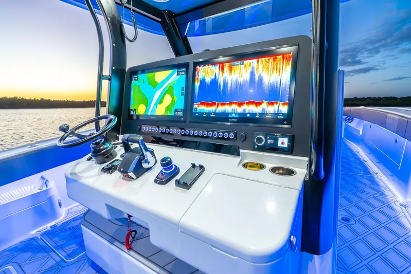  Yacht Photos Pics Control panel of 2025 Freeman 43 boat with navigation screens at sunset.