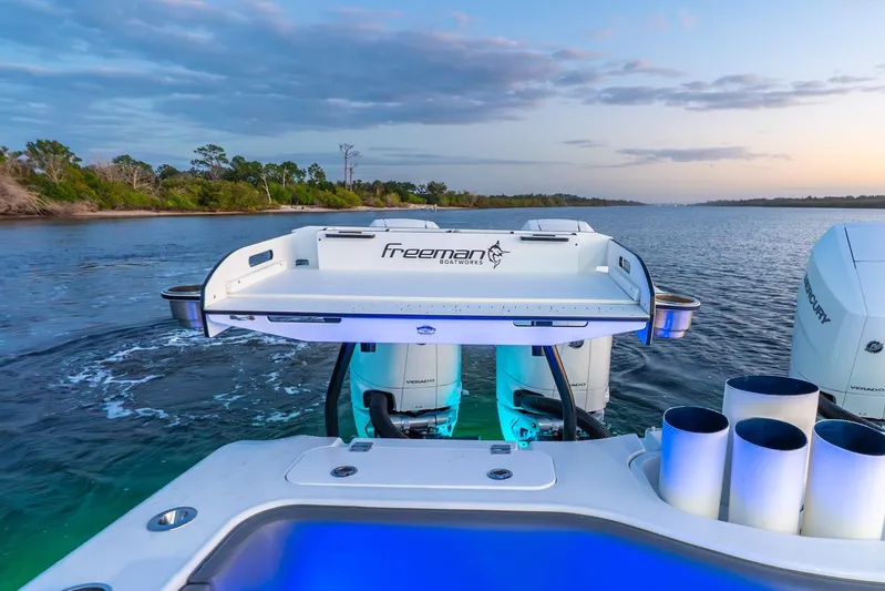  Yacht Photos Pics 2025 Freeman 43 boat with powerful engines cruising on a serene waterway at sunset.