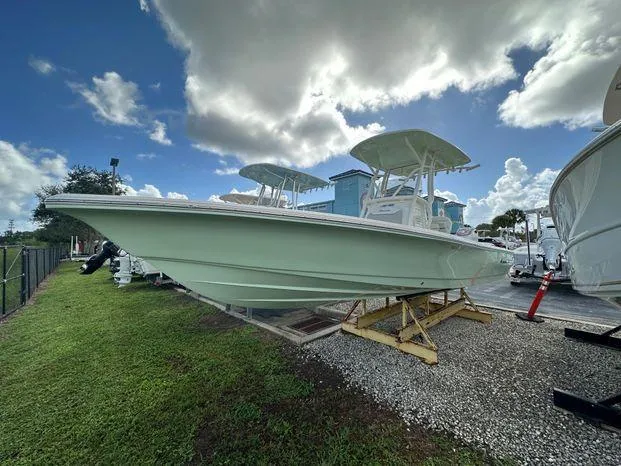 2024 Avenger 26 Avenger boat on display under a cloudy sky.