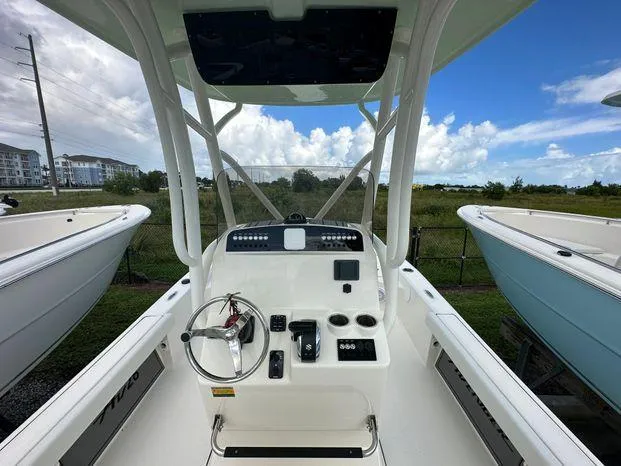 2024 Avenger 26 Avenger boat console with steering wheel and controls.