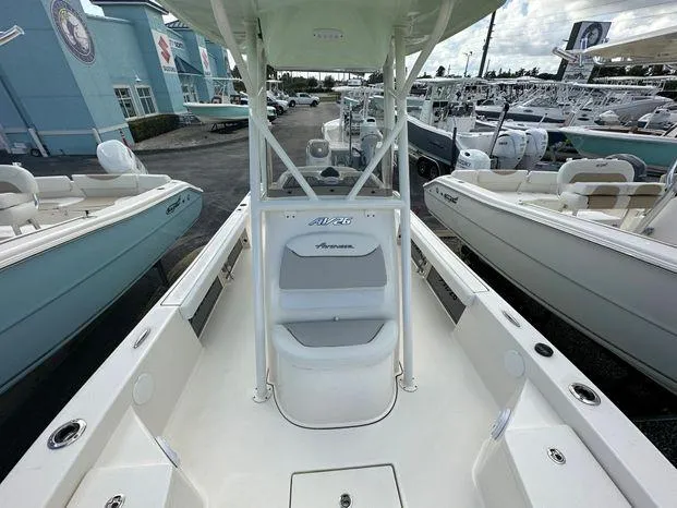 2024 Avenger 26 Avenger boat interior at a marina, showcasing seating and console.