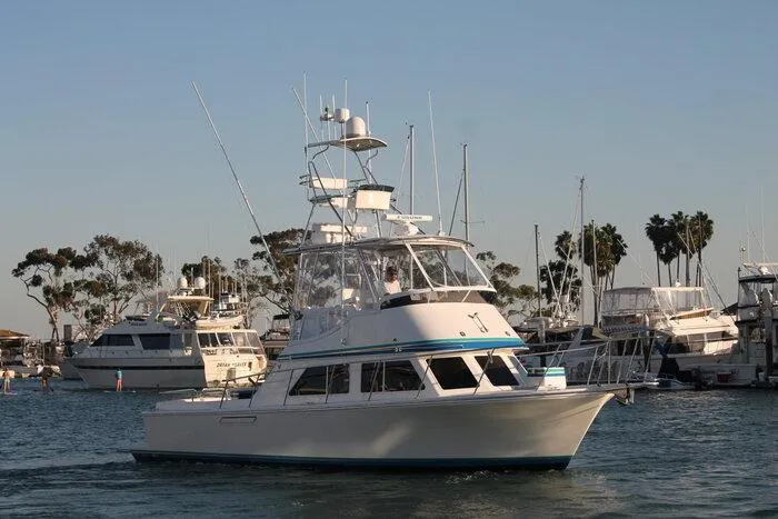  Yacht Photos Pics Radovich 34 boat from 1993 cruising in a marina with other yachts.
