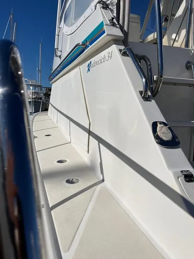  Yacht Photos Pics 1993 Radovich 34 boat, sleek white exterior, docked under clear blue sky.