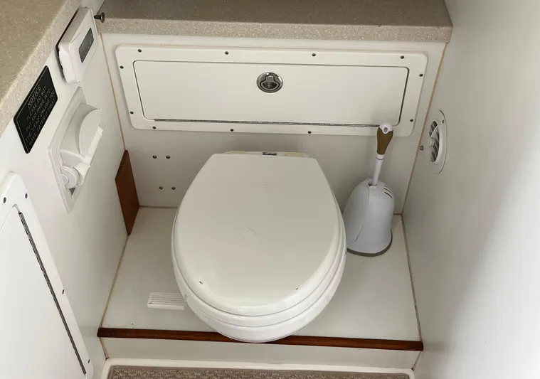  Yacht Photos Pics 1993 Radovich 34 boat bathroom with white marine toilet and storage compartment.