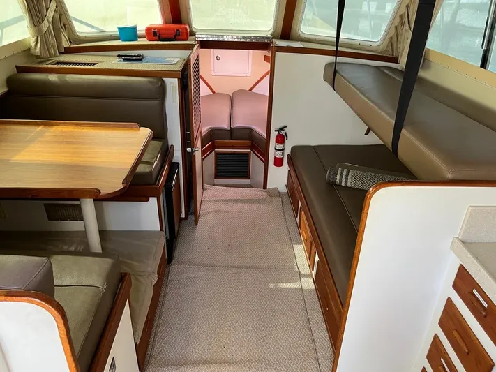  Yacht Photos Pics 1993 Radovich 34 boat interior with seating, table, and fire extinguisher.