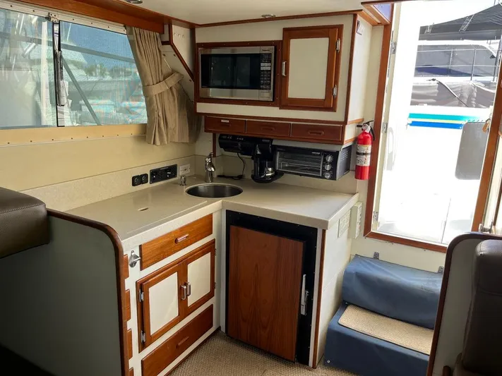  Yacht Photos Pics Compact kitchen area in a 1993 Radovich 34 boat, featuring a sink, microwave, and cabinetry.