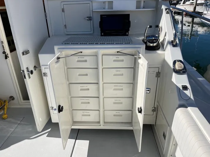  Yacht Photos Pics Storage cabinet on a 1993 Radovich 34 boat with open drawers and electronic equipment.